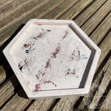 Load image into Gallery viewer, image shows a jesmonite hexagon shaped trinket tray base colour is cream with a terazzo effect using black jesmonite and copper powder.
