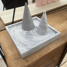 Load image into Gallery viewer, image shows a grey marble square jewellery tray with 2 grey marble ring cones on it. 
